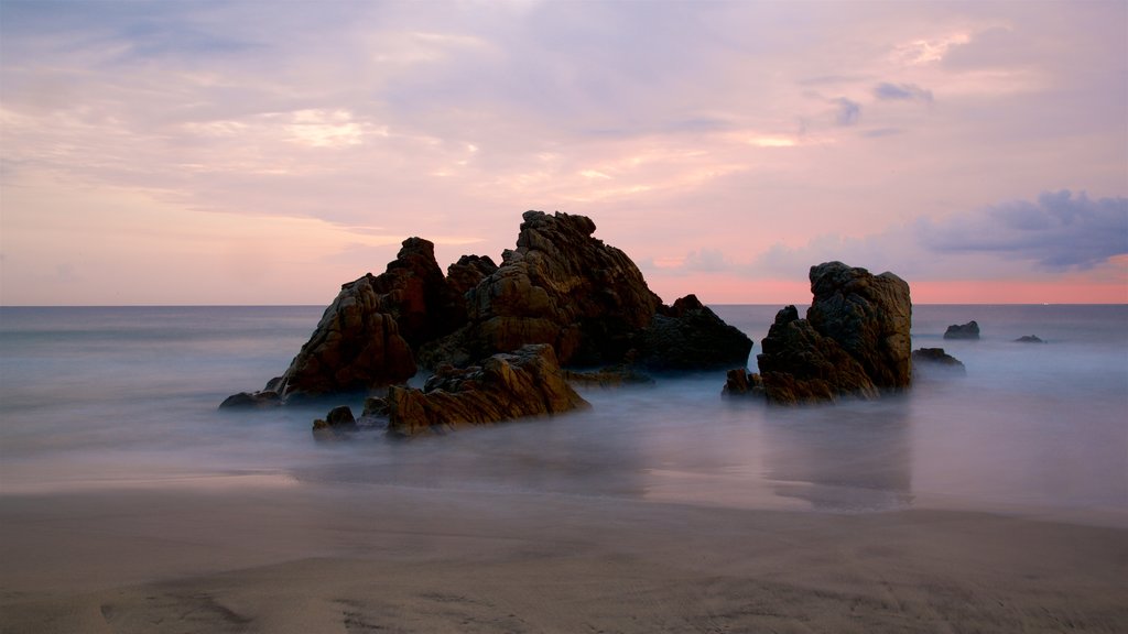 Zicatela Beach showing a sunset, a beach and general coastal views