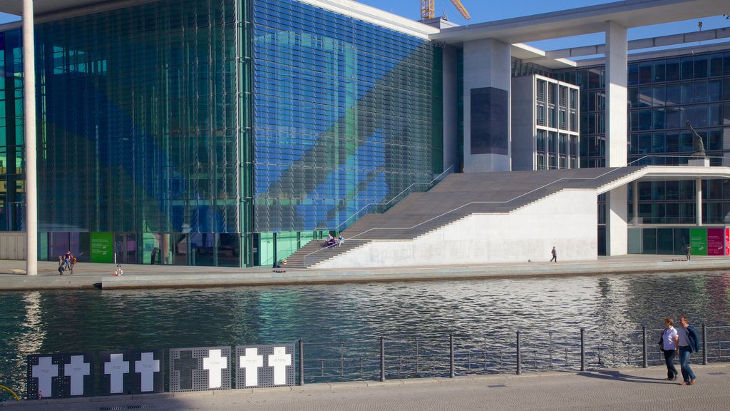 Reichstag Building featuring a pond, central business district and modern architecture