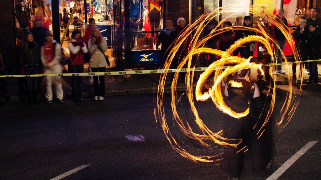 Yaletown featuring night scenes, performance art and street performance