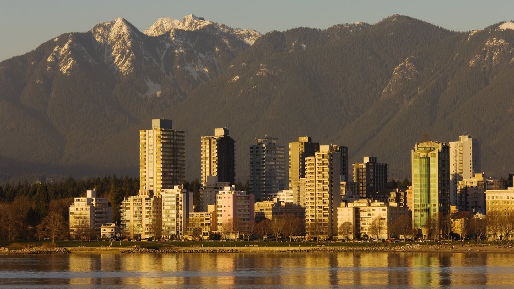 English Bay Inukshuk showing mountains, landscape views and a bay or harbor