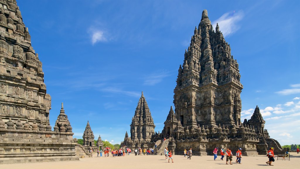 Prambanan Temple which includes heritage architecture and a square or plaza as well as a small group of people