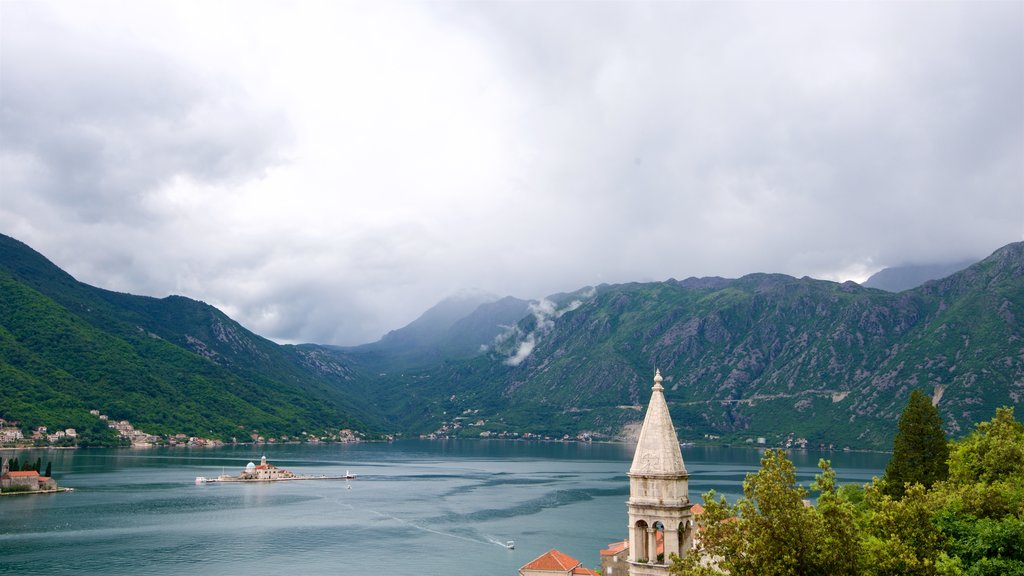 Kotor showing mountains, mist or fog and a coastal town