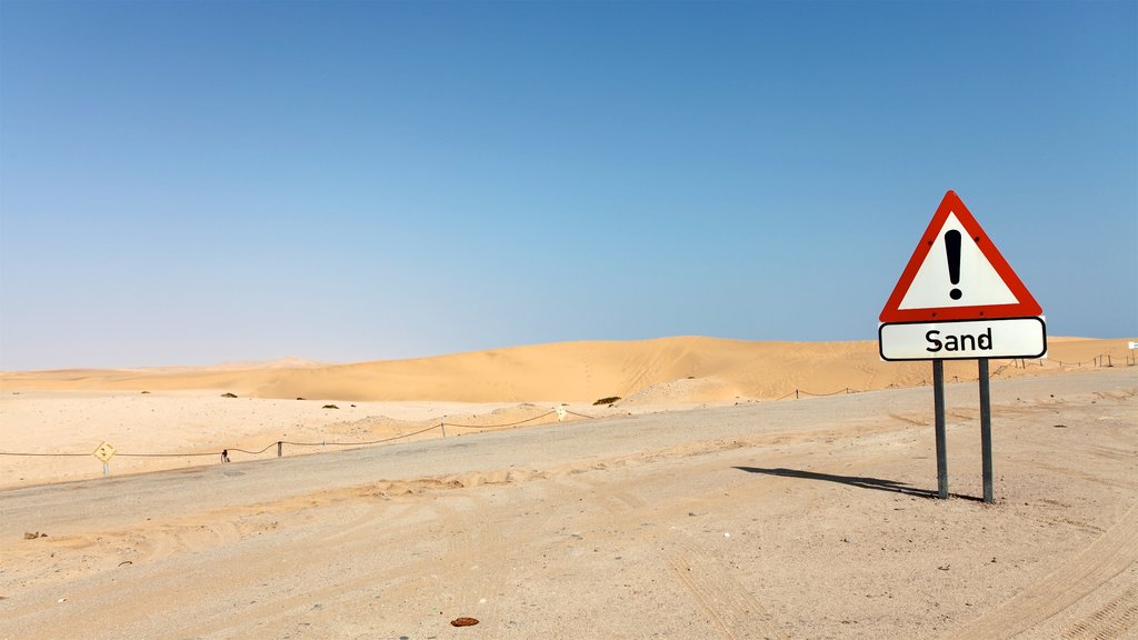 Swakopmund featuring signage and desert views