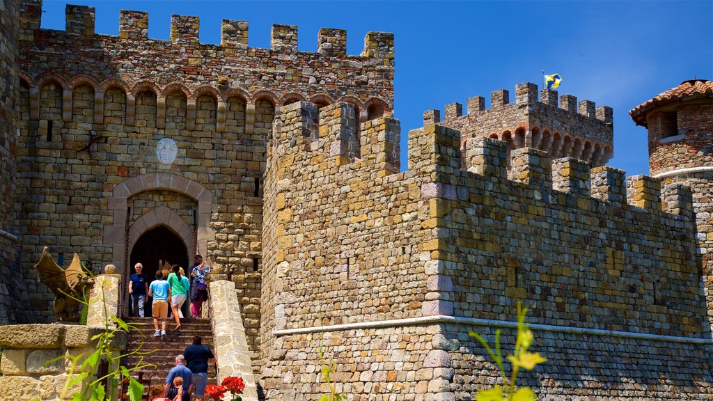 Castello di Amorosa ofreciendo elementos del patrimonio y castillo o palacio y también un pequeño grupo de personas