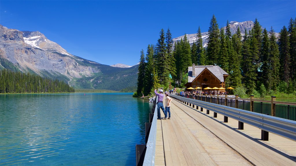 Yoho National Park featuring a lake or waterhole and a bridge as well as a couple