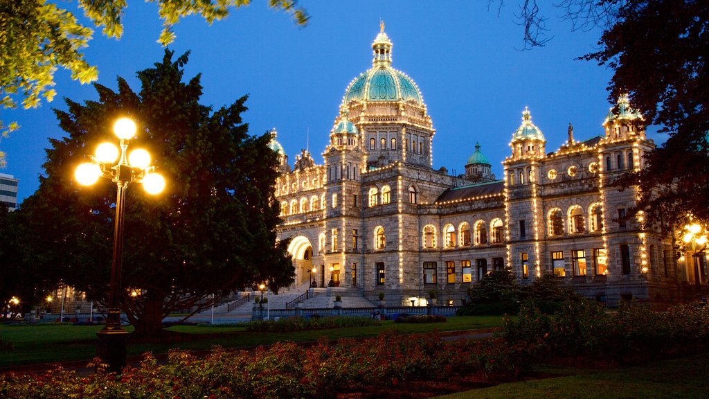 British Columbia Parliament Building showing night scenes, heritage architecture and a garden