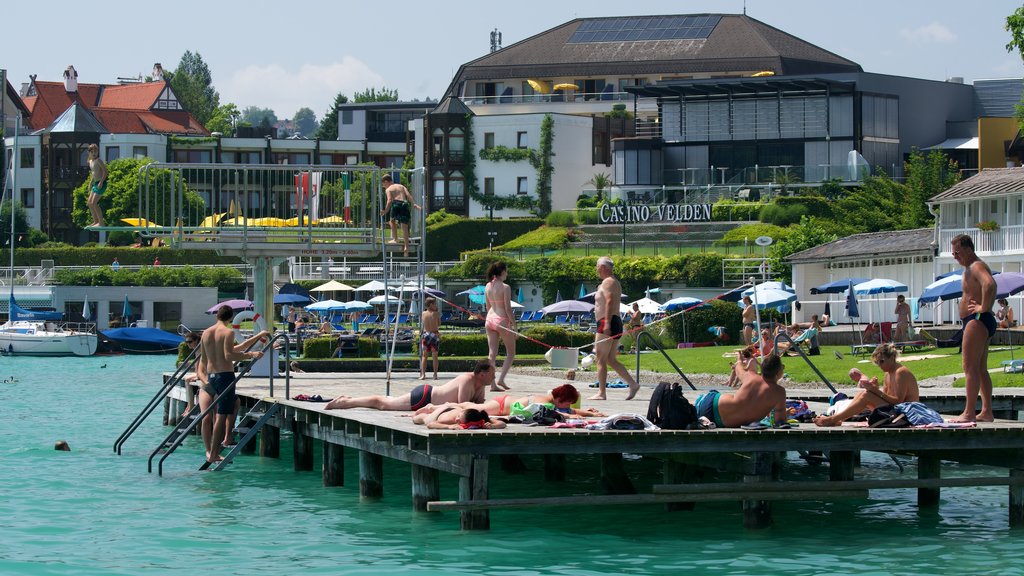 Velden am Woerthersee caracterizando natação e uma baía ou porto assim como um pequeno grupo de pessoas