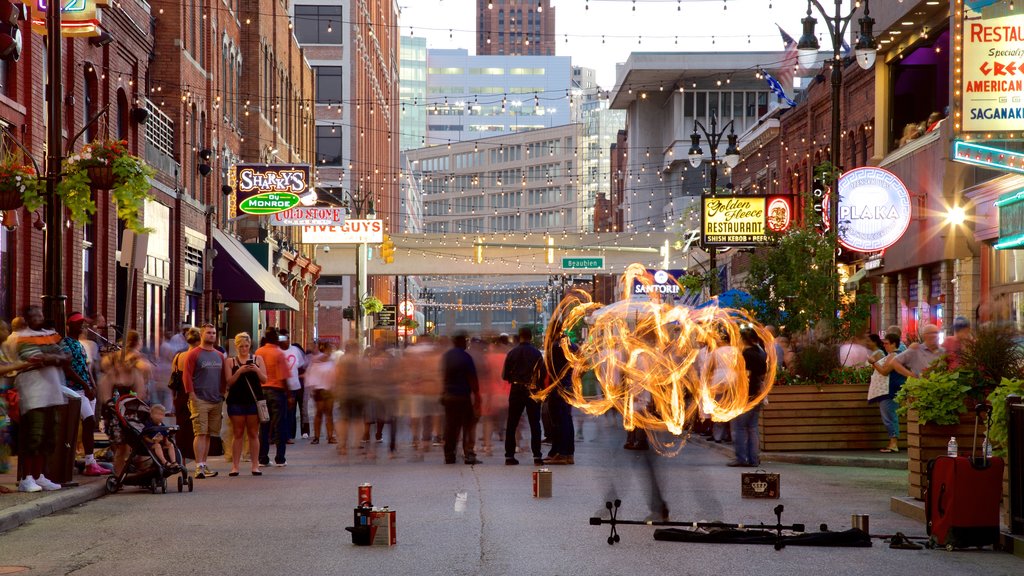 Greektown Historic District featuring signage as well as a large group of people