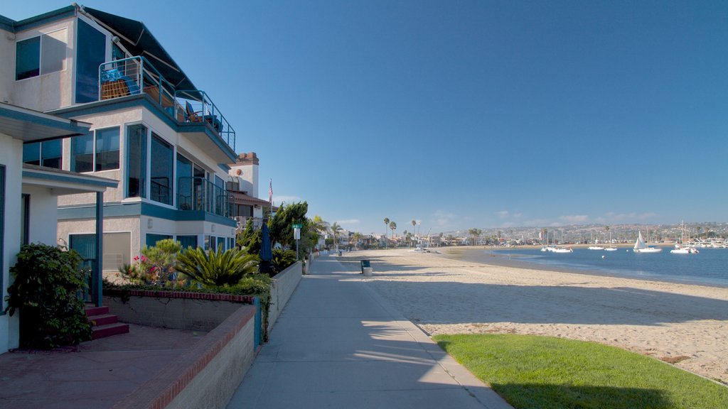 Mission Beach showing a house, a sandy beach and a bay or harbour