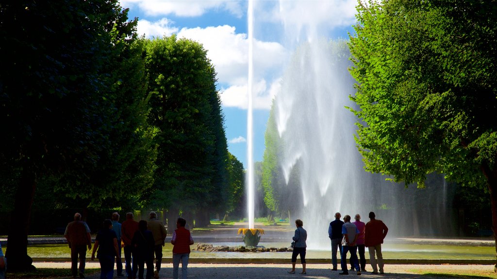 Great Garden featuring a fountain as well as a small group of people