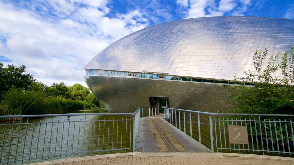 Universum Science Center featuring modern architecture and a lake or waterhole