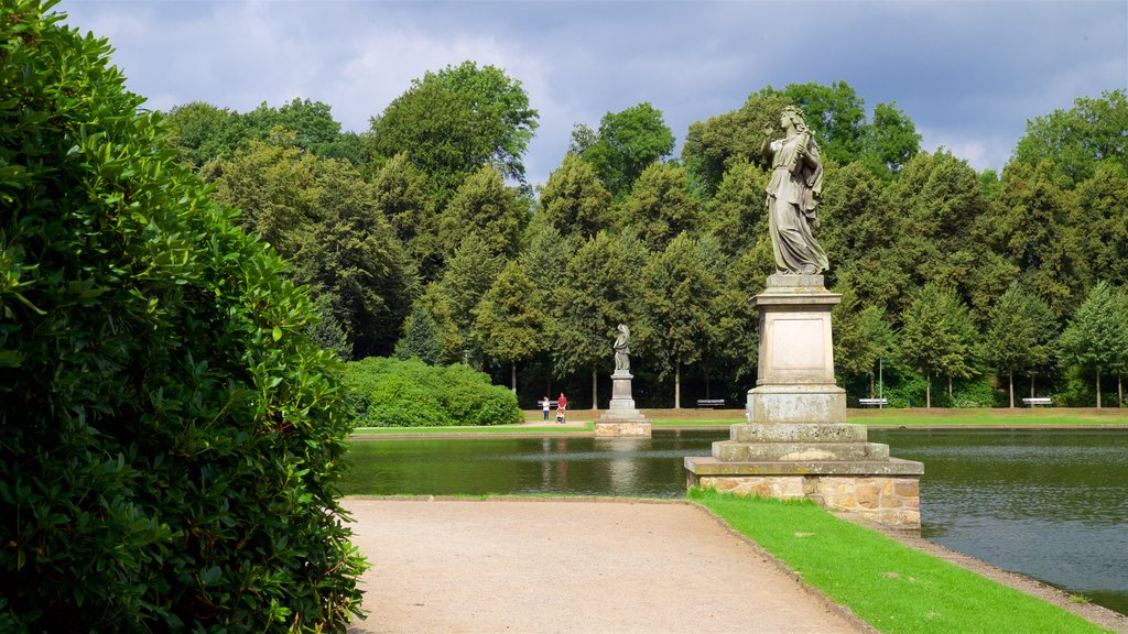 Bremen Buergerpark showing a lake or waterhole, a garden and a statue or sculpture