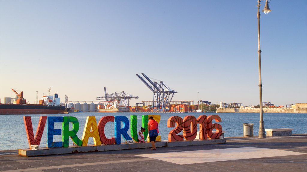 Veracruz showing a lake or waterhole and outdoor art as well as a family