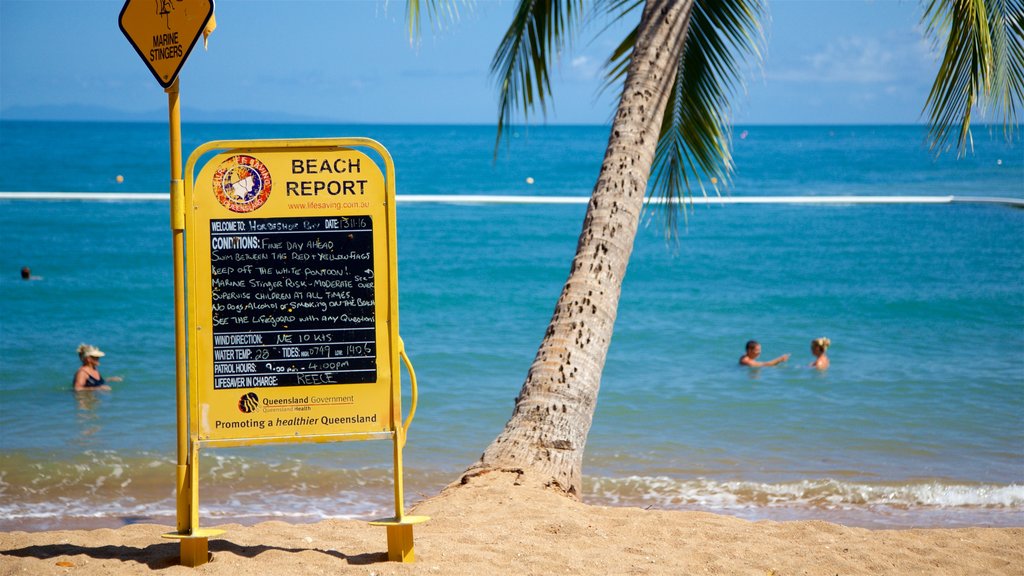 Horseshoe Bay Beach which includes general coastal views, signage and swimming