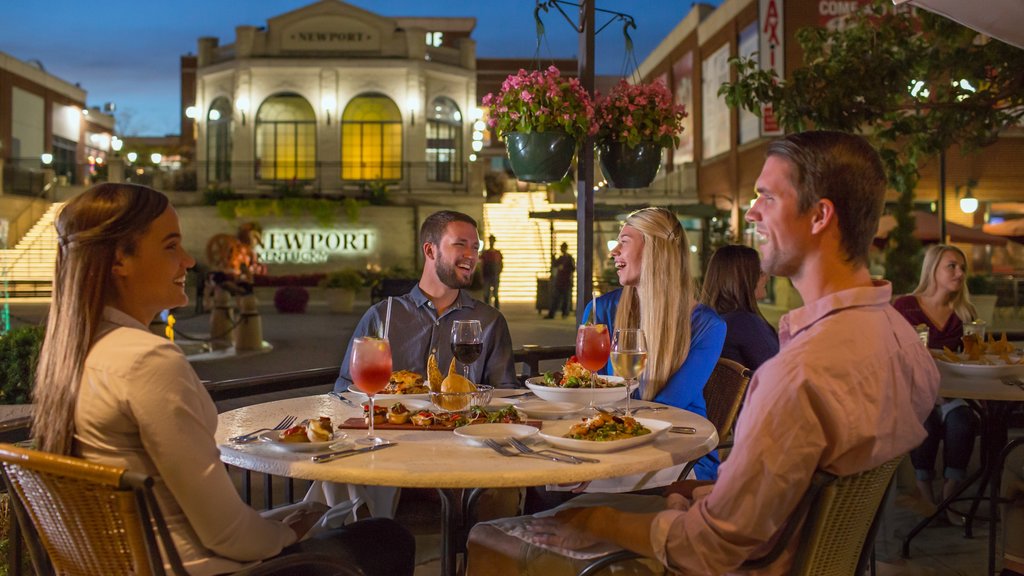 Newport on the Levee featuring outdoor eating and night scenes as well as a small group of people