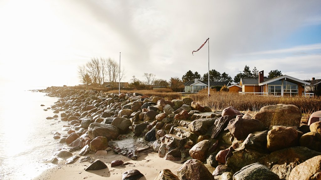 Juelsminde which includes general coastal views, rocky coastline and a sunset