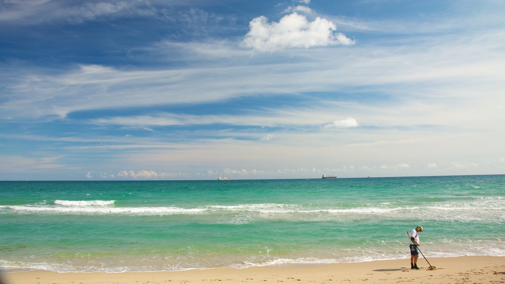 Hugh Taylor Birch State Park showing landscape views and a beach as well as an individual male