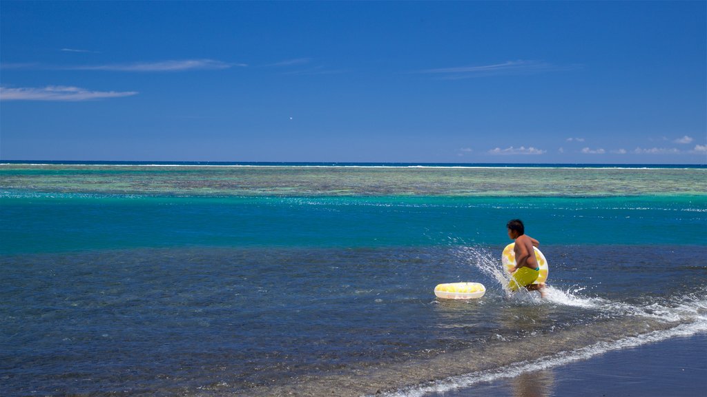 Black Sand Beach featuring general coastal views and swimming as well as an individual child