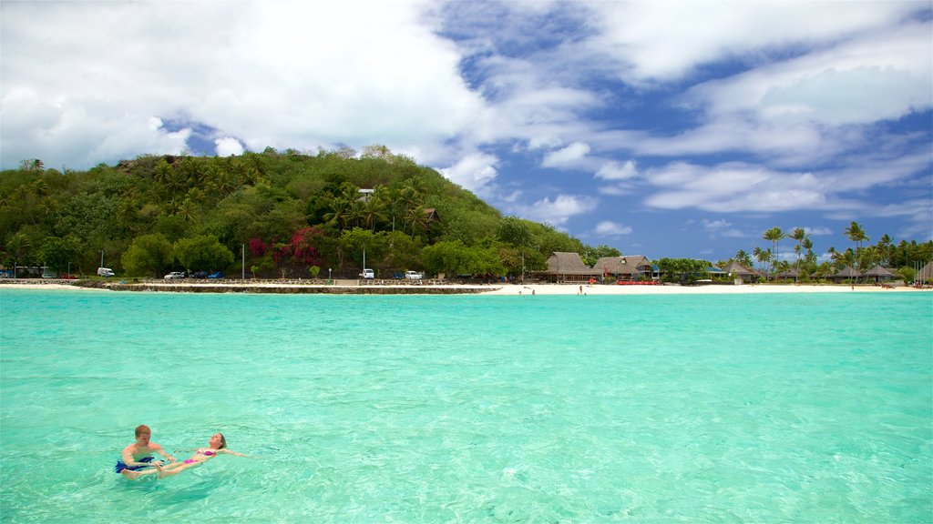 Matira Beach featuring tropical scenes, swimming and general coastal views