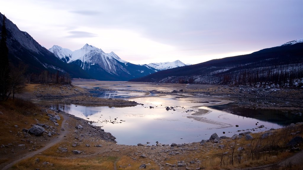 Lago Medicine que incluye escenas tranquilas, montañas y un lago o abrevadero