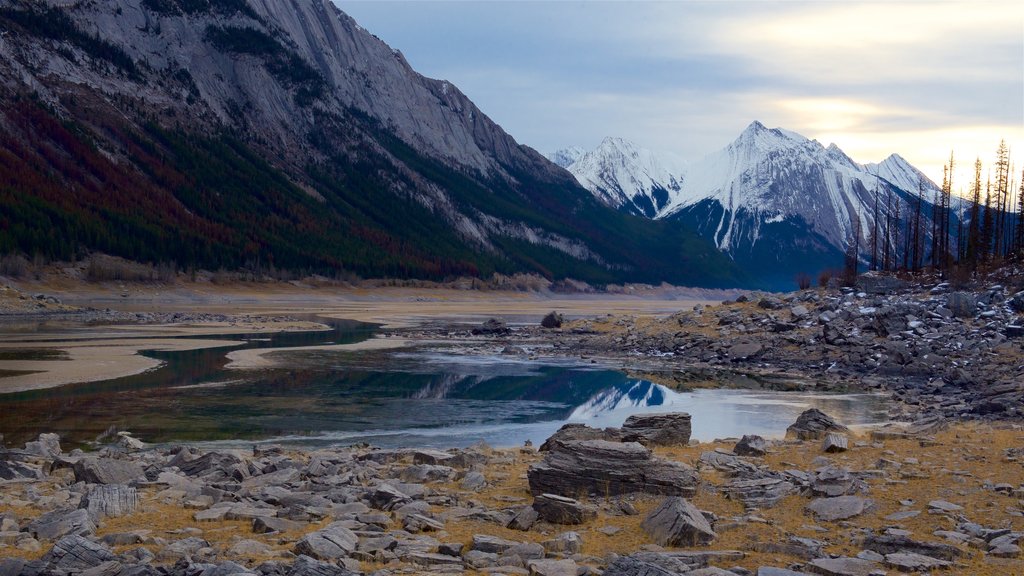 Medicine Lake which includes mountains, a lake or waterhole and snow