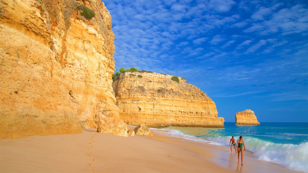 Marinha Beach which includes a sandy beach, general coastal views and rocky coastline