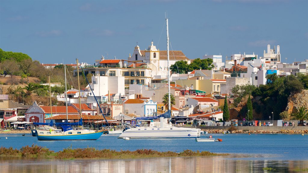 Alvor Beach featuring a bay or harbour and a city