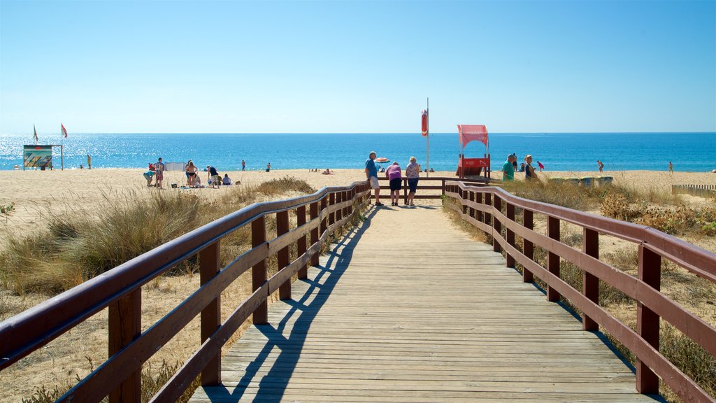 Alvor Beach which includes general coastal views, a bridge and a sandy beach