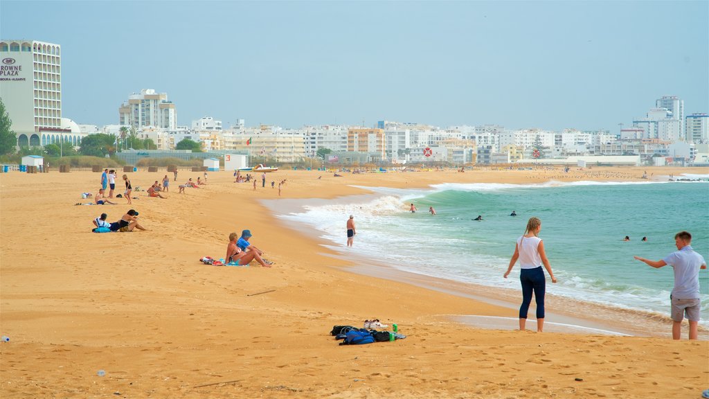 Marina Beach which includes a sandy beach, a city and general coastal views