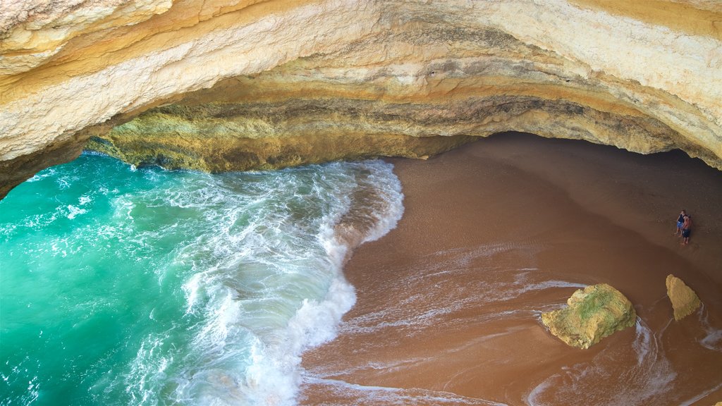 Benagil Beach which includes rugged coastline, a beach and general coastal views