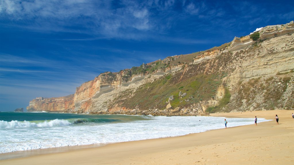 Nazare Beach which includes a beach, rocky coastline and general coastal views