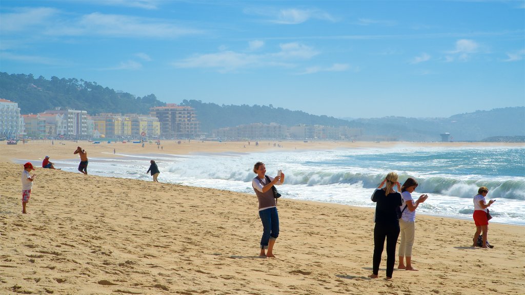 Nazare Beach which includes waves, general coastal views and a sandy beach