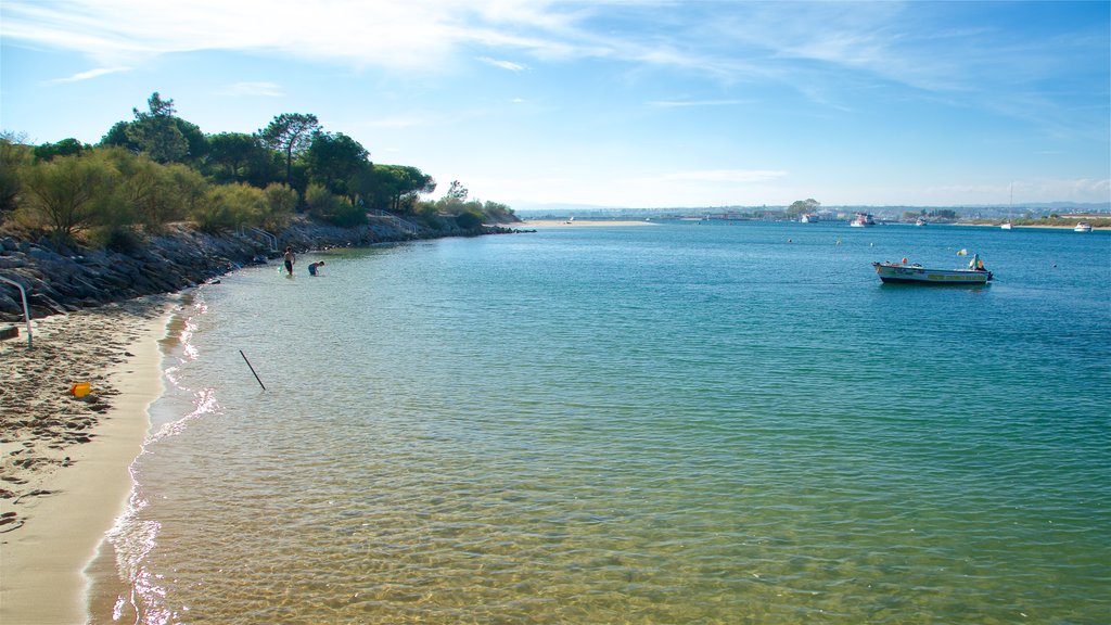 Ilha de Tavira Beach which includes a sandy beach and a river or creek