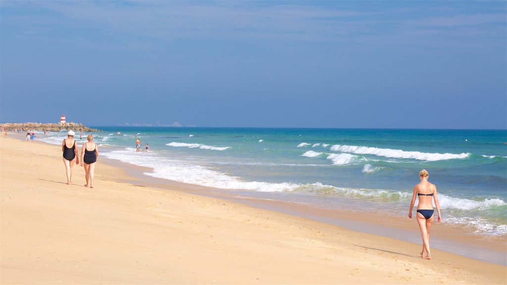 Ilha de Tavira Beach showing general coastal views and a sandy beach as well as an individual female