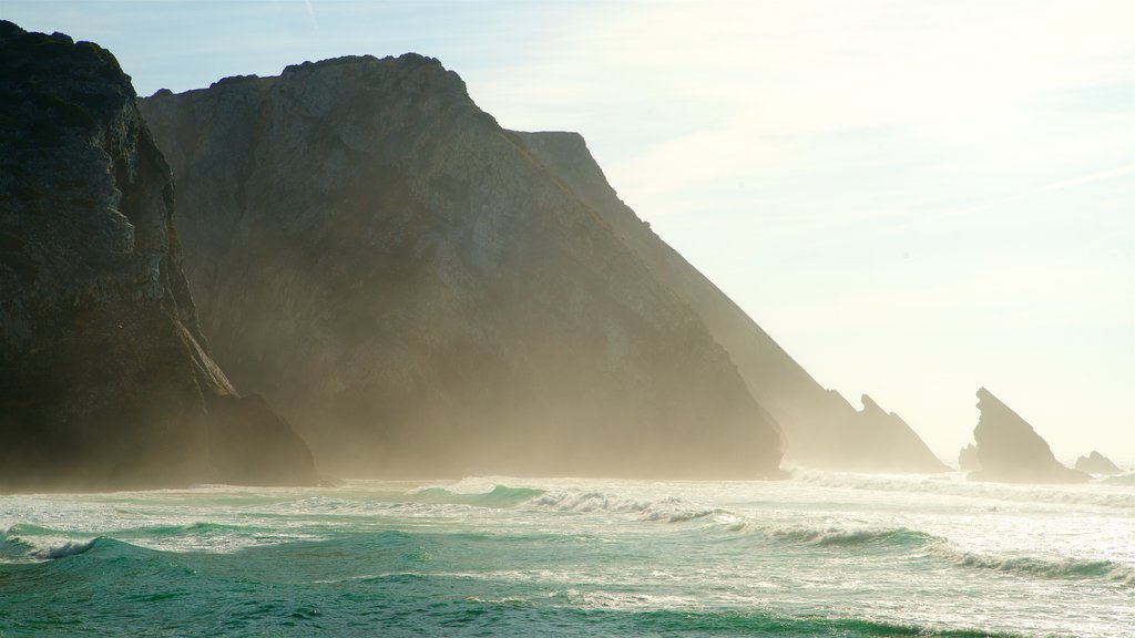 Adraga Beach featuring rugged coastline, general coastal views and a sunset