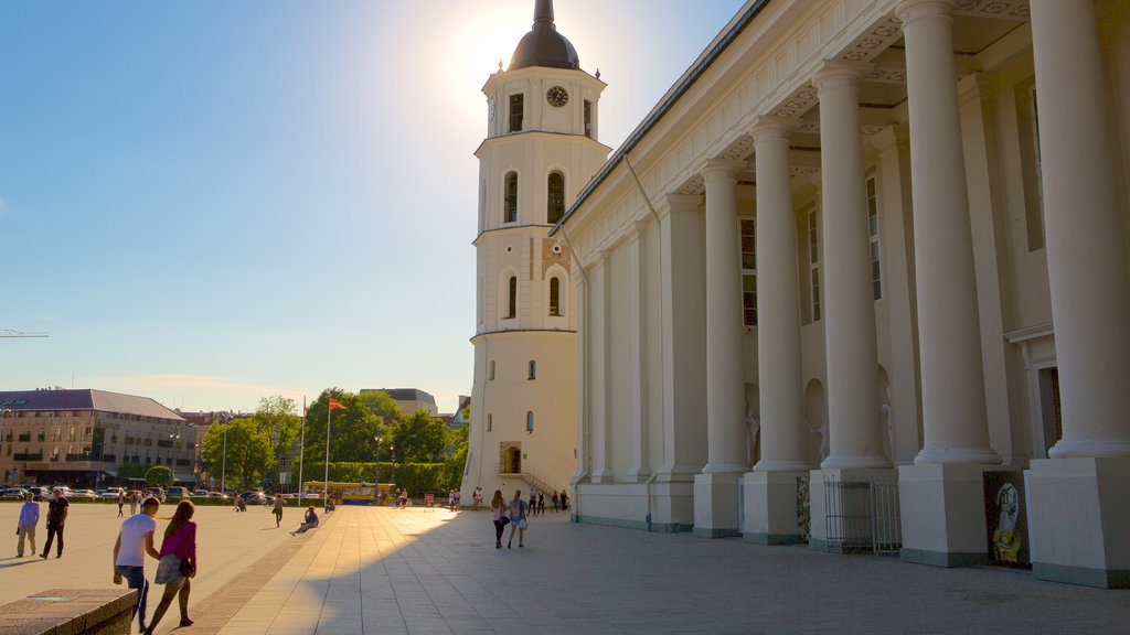 Vilnius Cathedral showing heritage elements and a square or plaza as well as a small group of people