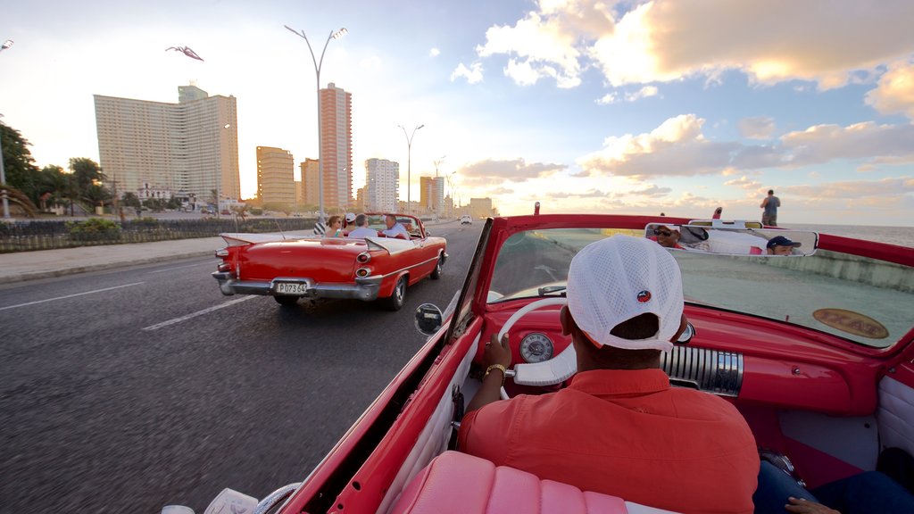 Malecón showing a city, a sunset and heritage elements