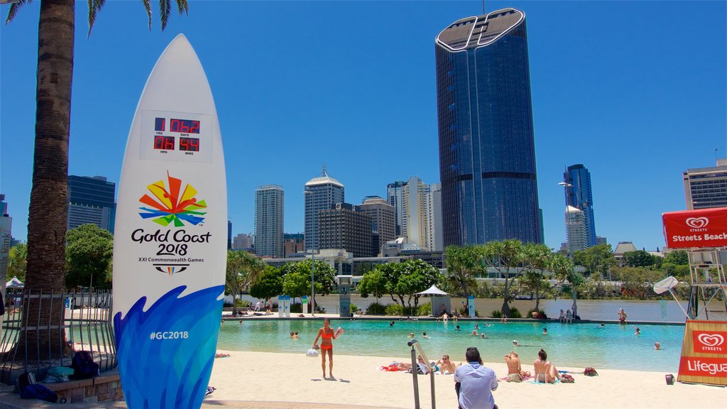 Southbank Parklands featuring signage, a skyscraper and a pool