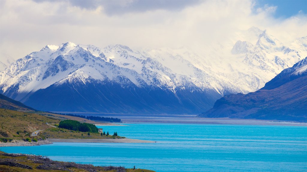 Lake Pukaki showing a lake or waterhole, snow and mist or fog