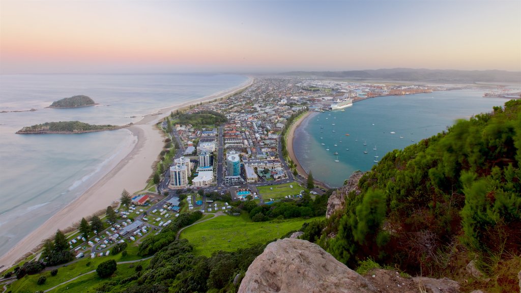 Mount Maunganui which includes a sunset, a bay or harbor and a coastal town