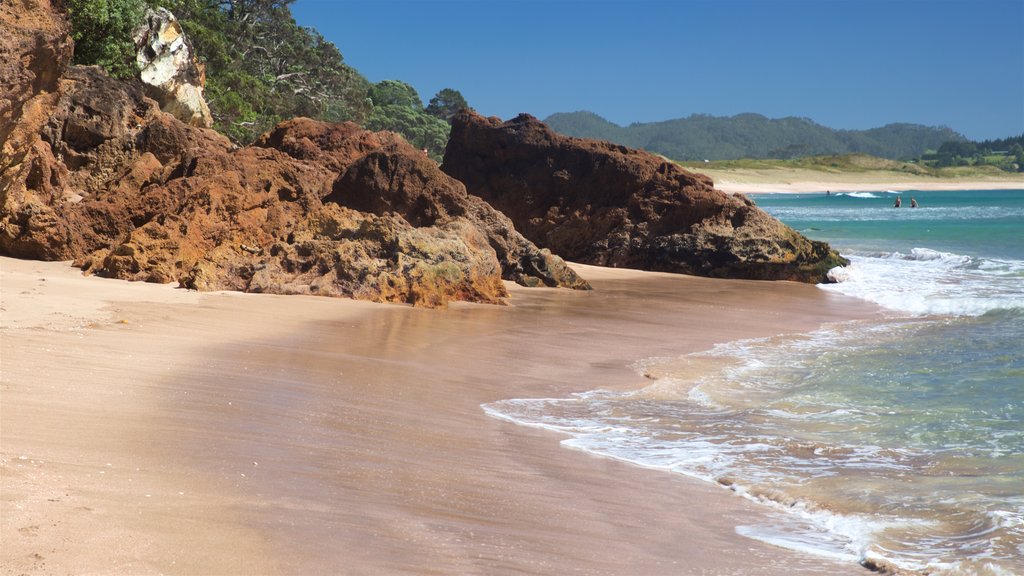 Hot Water Beach which includes a sandy beach, general coastal views and rugged coastline