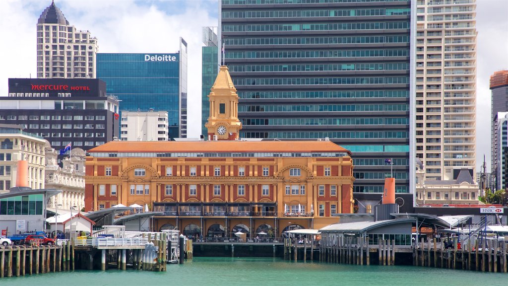 Auckland Ferry Terminal featuring a skyscraper, heritage elements and a bay or harbour