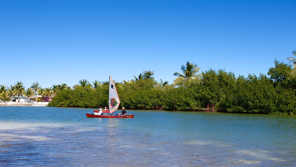 Curry Hammock State Park featuring boating and a river or creek as well as a small group of people