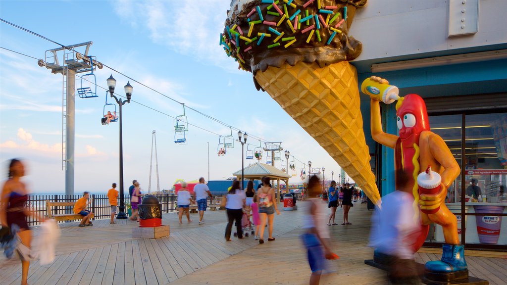 Seaside Heights showing a gondola and signage as well as a small group of people