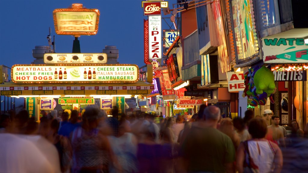 Seaside Heights featuring signage and night scenes as well as a large group of people