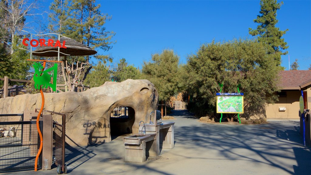 Happy Hollow Park and Zoo showing signage, a garden and a playground