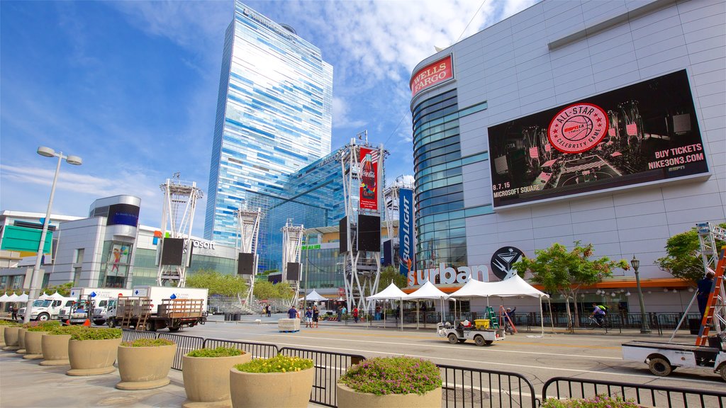 Staples Center which includes signage, a city and modern architecture