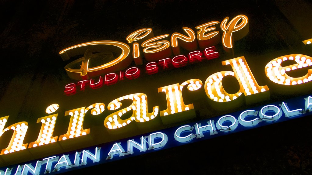 Hollywood Boulevard showing signage and night scenes