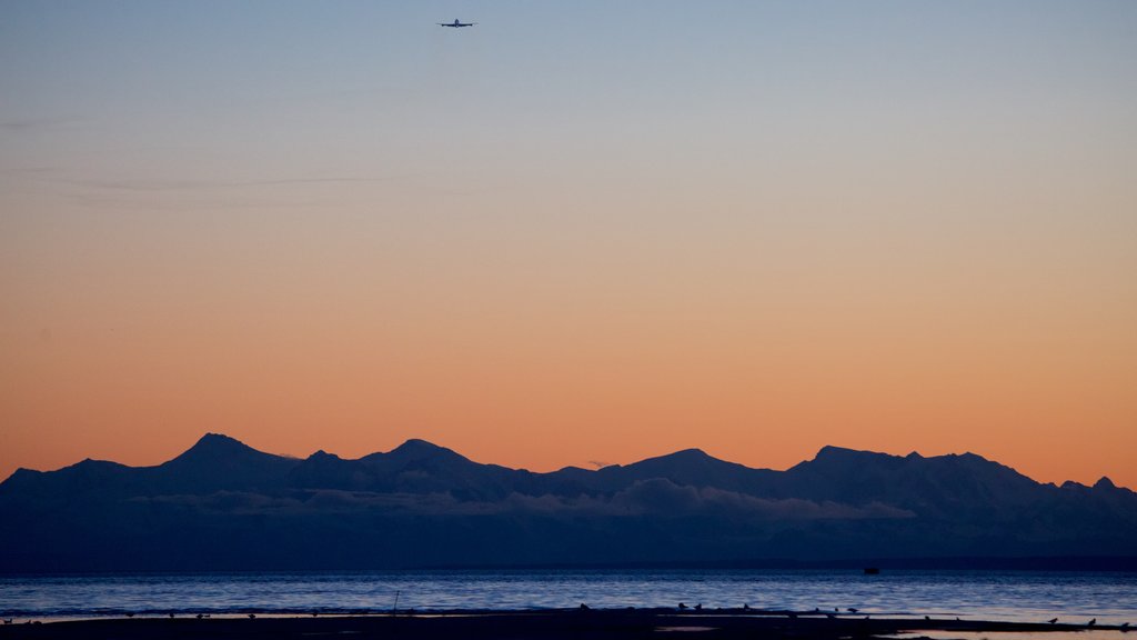 Tony Knowles Coastal Trail which includes a sunset, landscape views and a lake or waterhole