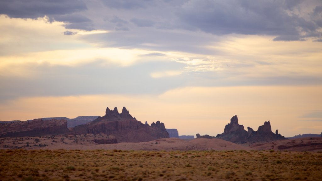 Monument Valley showing a sunset, a gorge or canyon and tranquil scenes